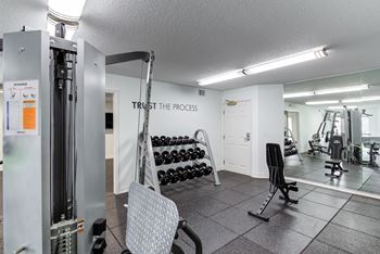 a fitness center with a treadmill and other exercise equipment